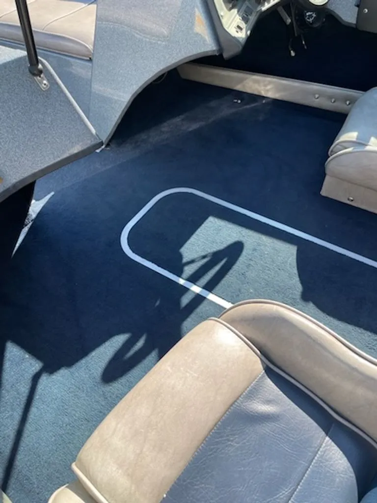 Slide: The Image of Interior of a 1984 Ebbtide Dyna-Trak boat with blue carpeting and gray seats. - 8