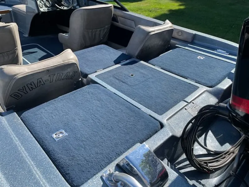 Slide: The Image of Interior view of a 1984 Ebbtide Dyna-Trak boat with blue upholstery and steering console. - 3