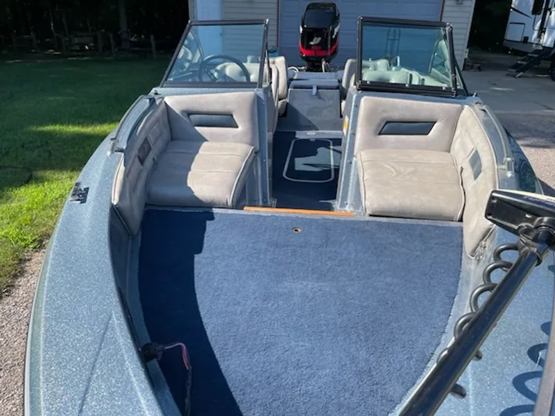 Slide: The Image of An Ebbtide Dyna-Trak boat from 1984 with gray seats and blue carpeting. - 1
