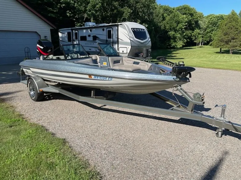 Slide: The Image of A 1984 Ebbtide Dyna-Trak boat on a trailer beside an RV. - 6