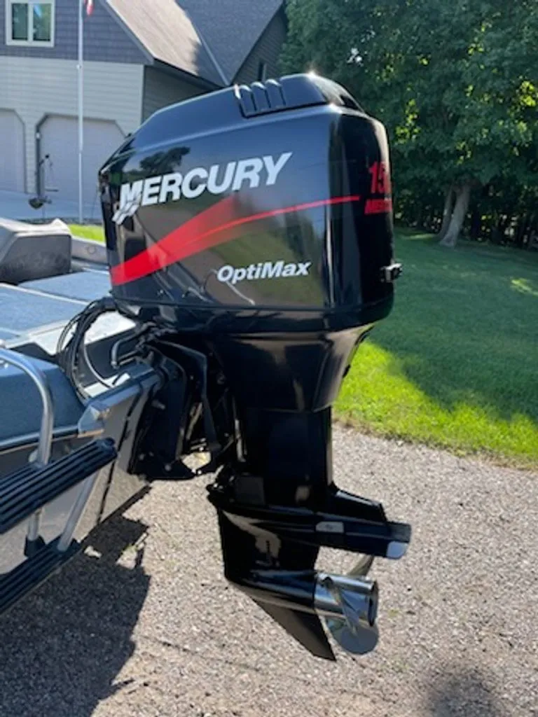 Slide: The Image of A Mercury OptiMax outboard motor on a boat, parked on a paved area. - 4
