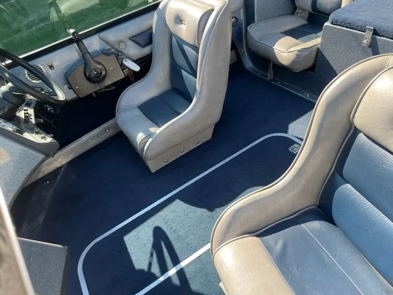 Slide: The Image of Interior of a 1984 Ebbtide Dyna-Trak boat with blue and gray seating. - 7