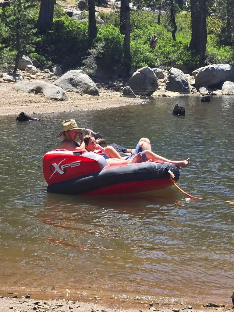 Slide: The Image of Two people relax on an inflatable boat near a lake's shore. - 11