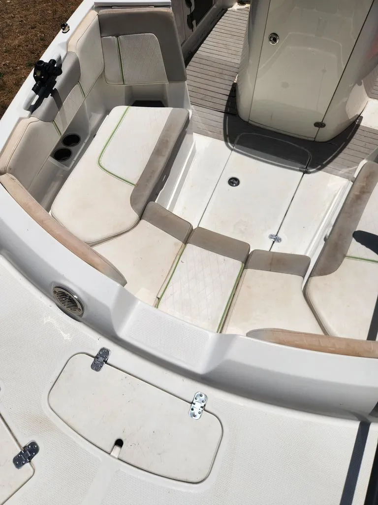 Slide: The Image of The image shows the seating area of a 2018 Tahoe 2150 CC boat with white upholstery. - 4