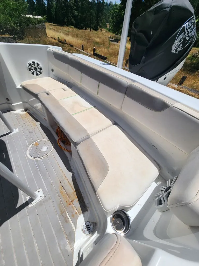 Slide: The Image of The image shows the interior of a 2018 Tahoe 2150 CC boat with cushioned seating. - 3