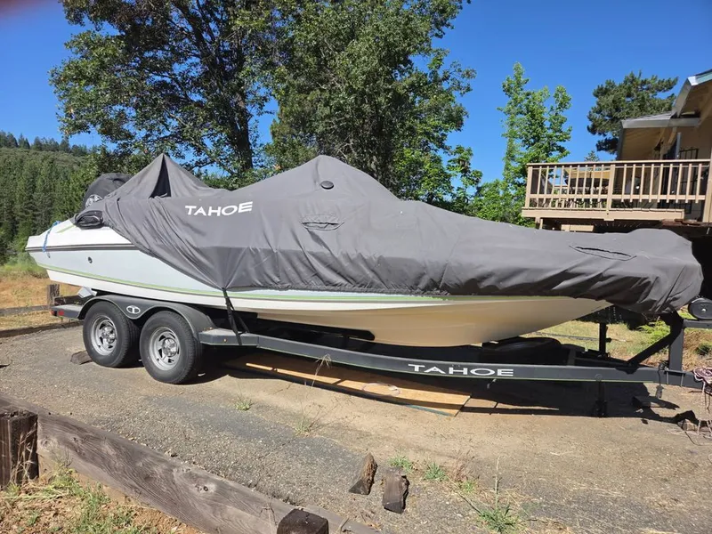 Slide: The Image of A 2018 Tahoe 2150 CC boat on a trailer, covered with a gray tarp. - 7