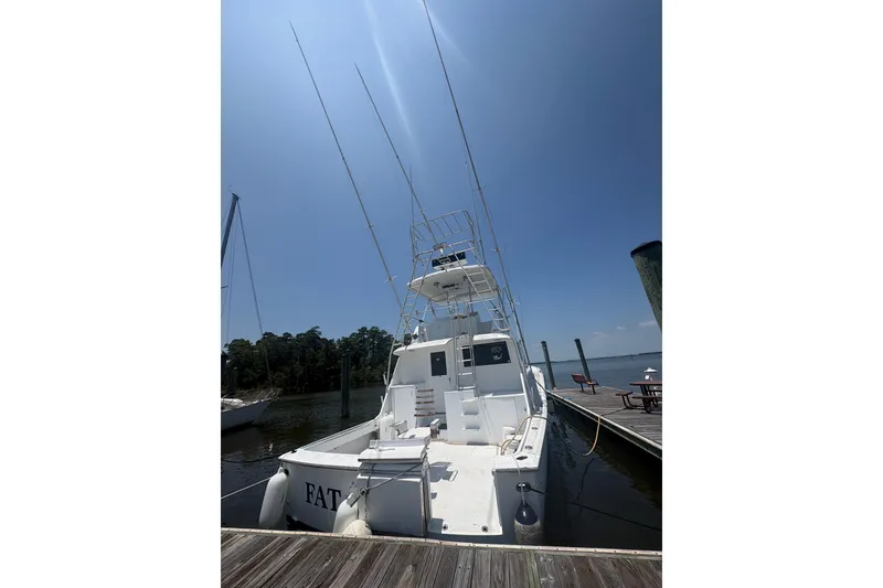 Slide: The Image of 1973 Hatteras 53 Convertible yacht docked under clear blue sky. - 96
