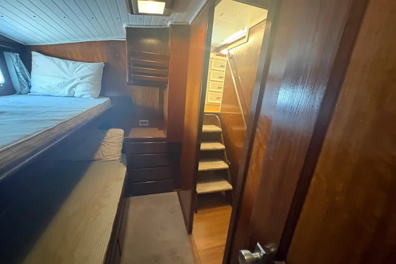 Slide: The Image of Interior of 1973 Hatteras 53 Convertible yacht with wooden paneling and bunk beds. - 56