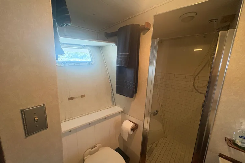 Slide: The Image of Bathroom interior of a 1973 Hatteras 53 Convertible yacht with shower and window. - 55