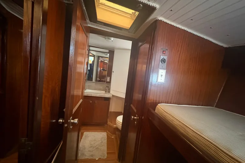 Slide: The Image of Interior of 1973 Hatteras 53 Convertible yacht with wood paneling and compact bathroom. - 58