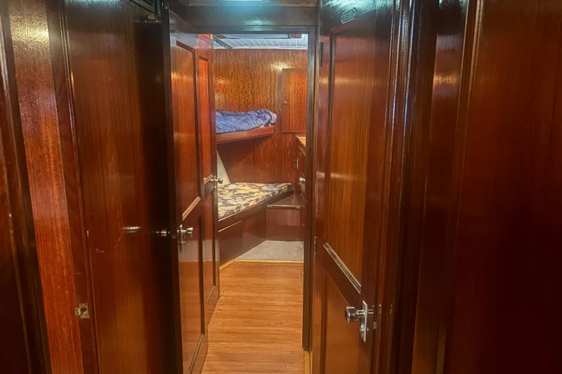 Slide: The Image of Interior of 1973 Hatteras 53 Convertible yacht with wooden paneling and bunk beds. - 33