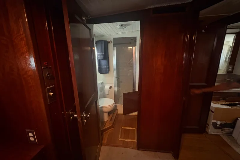 Slide: The Image of Interior of 1973 Hatteras 53 Convertible yacht bathroom with wooden cabinetry and shower. - 46