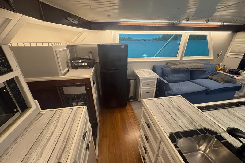 Slide: The Image of Interior of a 1973 Hatteras 53 Convertible yacht with modern kitchen and seating area. - 22