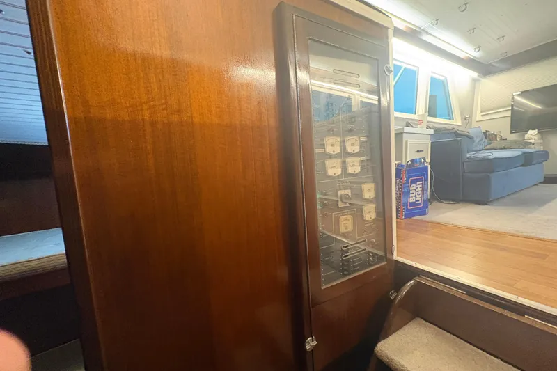 Slide: The Image of Interior of a 1973 Hatteras 53 Convertible yacht with wood paneling and electrical panel. - 31
