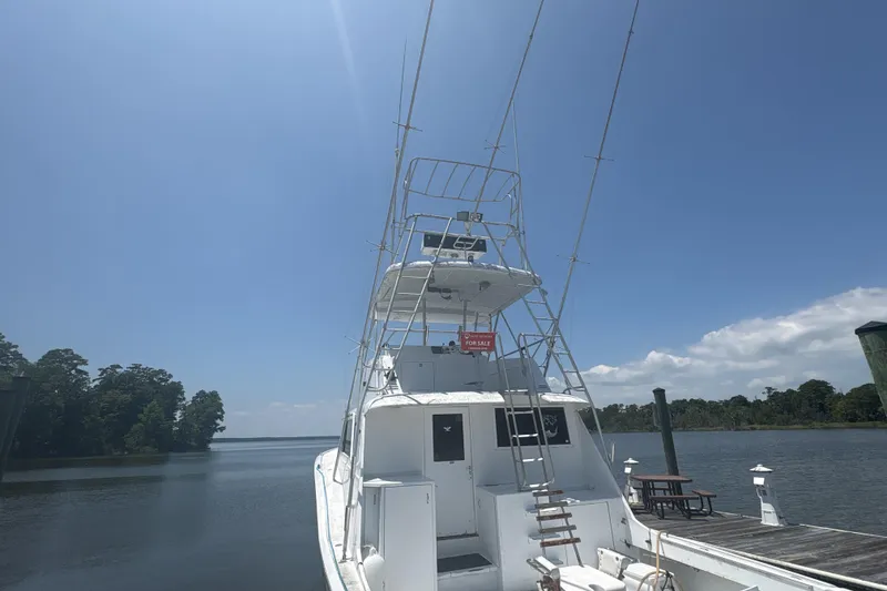 Slide: The Image of 1973 Hatteras 53 Convertible yacht docked under clear blue sky. - 7
