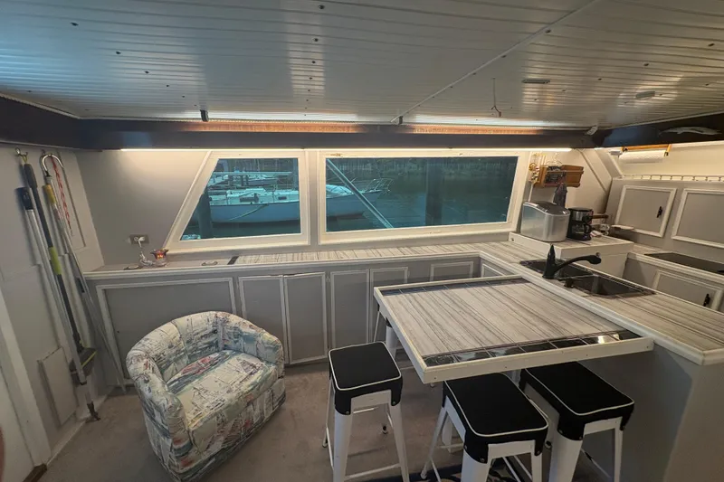 Slide: The Image of Interior of a 1973 Hatteras 53 Convertible yacht with modern kitchen and seating area. - 19