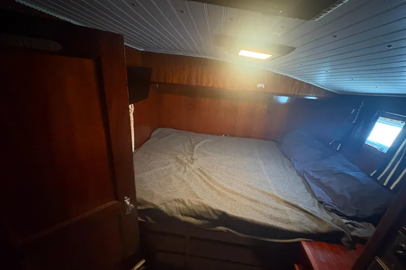 Slide: The Image of Cozy cabin interior of a 1973 Hatteras 53 Convertible yacht with wooden paneling. - 44