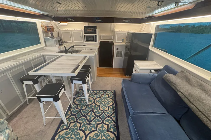 Slide: The Image of Interior of a 1973 Hatteras 53 Convertible yacht with modern kitchen and seating area. - 15