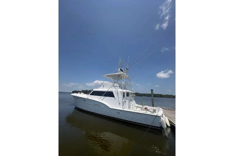 Slide: The Image of 1973 Hatteras 53 Convertible yacht docked on a sunny day, clear blue sky. - 89