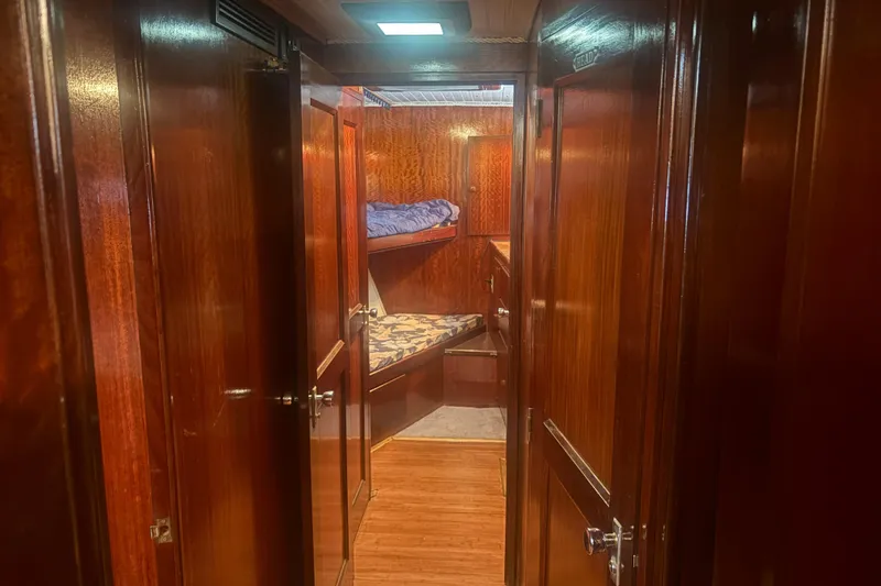 Slide: The Image of Interior of 1973 Hatteras 53 Convertible yacht with wooden paneling and bunk beds. - 34