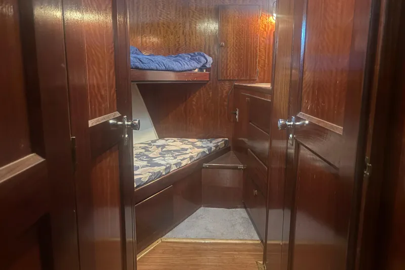 Slide: The Image of Cozy cabin interior of 1973 Hatteras 53 Convertible with wooden finish and bunk beds. - 34