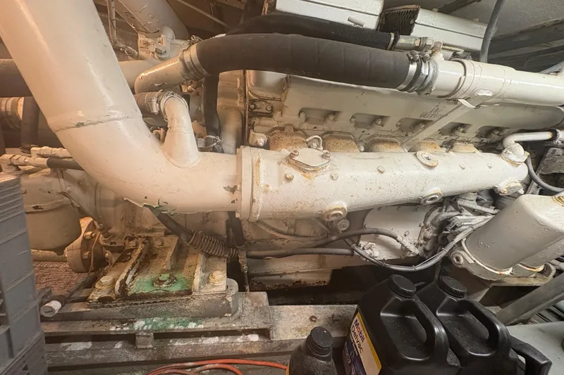 Slide: The Image of Engine compartment of a 1973 Hatteras 53 Convertible boat, showcasing mechanical components. - 111
