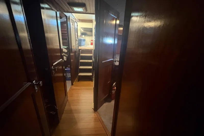 Slide: The Image of Interior hallway of a 1973 Hatteras 53 Convertible yacht with wooden paneling. - 28