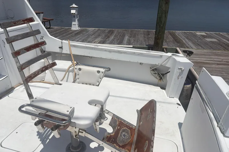 Slide: The Image of 1973 Hatteras 53 Convertible fishing chair on deck by the dock. - 11