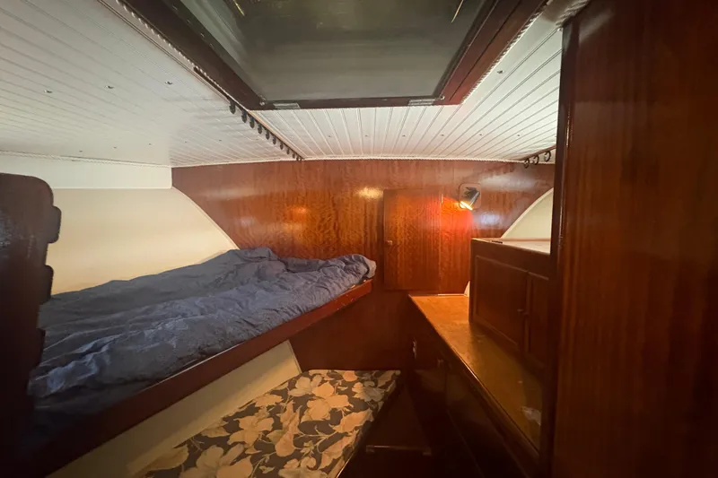 Slide: The Image of Cozy cabin interior of 1973 Hatteras 53 Convertible yacht with wooden furnishings and bunk beds. - 36