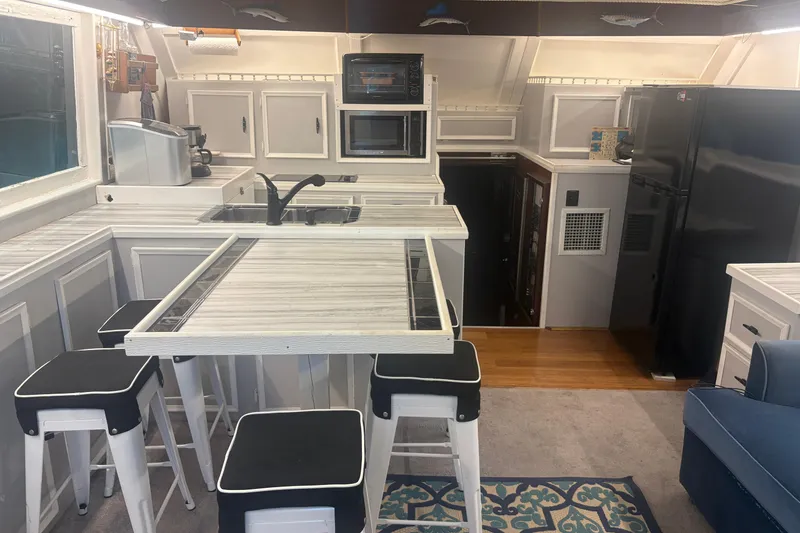 Slide: The Image of Interior of a 1973 Hatteras 53 Convertible yacht with modern kitchen and seating area. - 18