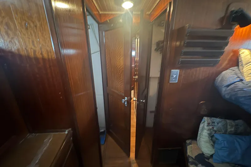 Slide: The Image of Interior of a 1973 Hatteras 53 Convertible yacht with wooden paneling and cozy cabin space. - 42