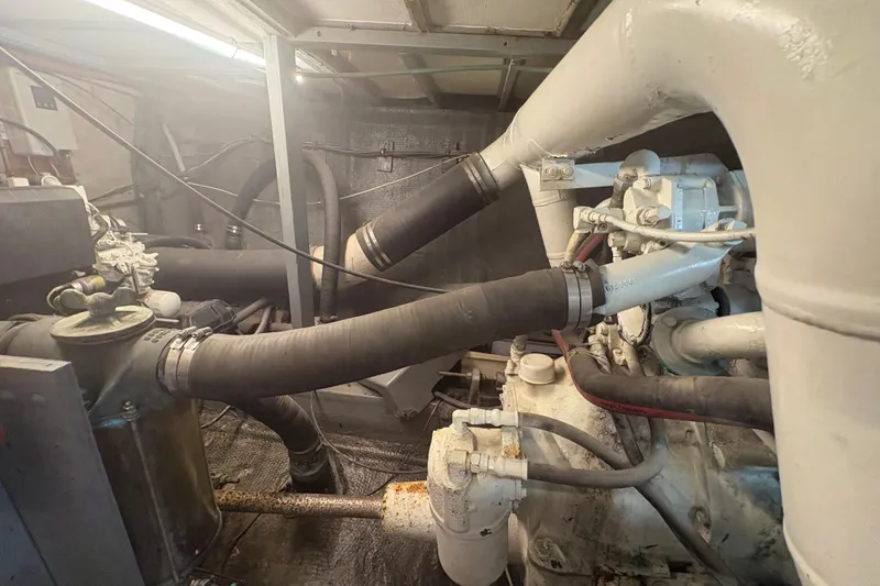 Slide: The Image of Engine room of a 1973 Hatteras 53 Convertible yacht, showcasing mechanical components. - 108