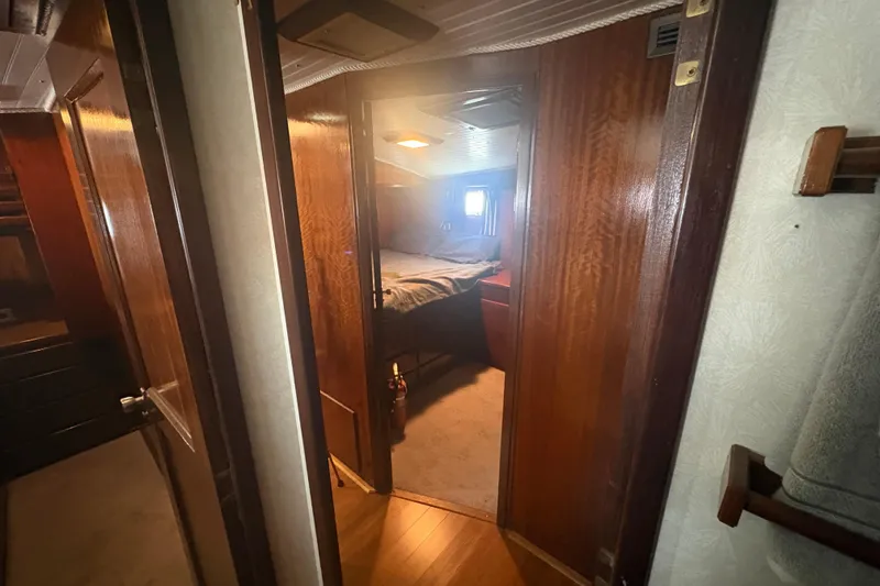 Slide: The Image of Interior view of 1973 Hatteras 53 Convertible yacht cabin with wooden finishes. - 62