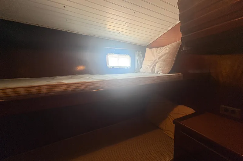 Slide: The Image of Cozy cabin interior of 1973 Hatteras 53 Convertible yacht with single bed and porthole. - 60