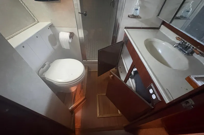 Slide: The Image of Bathroom interior of a 1973 Hatteras 53 Convertible yacht with sink and shower. - 50