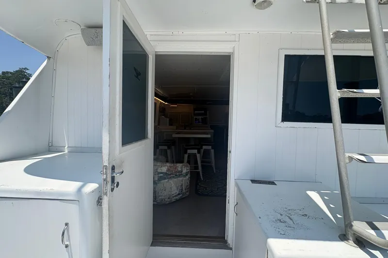 Slide: The Image of 1973 Hatteras 53 Convertible yacht interior view with open door and ladder. - 13