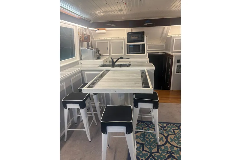 Slide: The Image of Interior of 1973 Hatteras 53 Convertible yacht with modern kitchen and bar stools. - 17