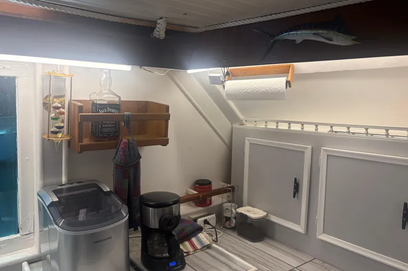 Slide: The Image of 1973 Hatteras 53 Convertible kitchen with appliances, cabinets, and nautical decor. - 27