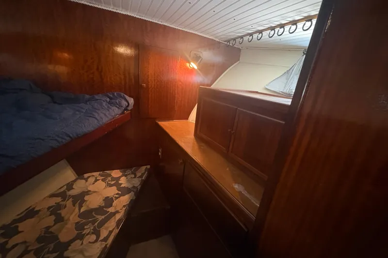 Slide: The Image of Cozy cabin interior of 1973 Hatteras 53 Convertible with wooden furnishings and bunk beds. - 37