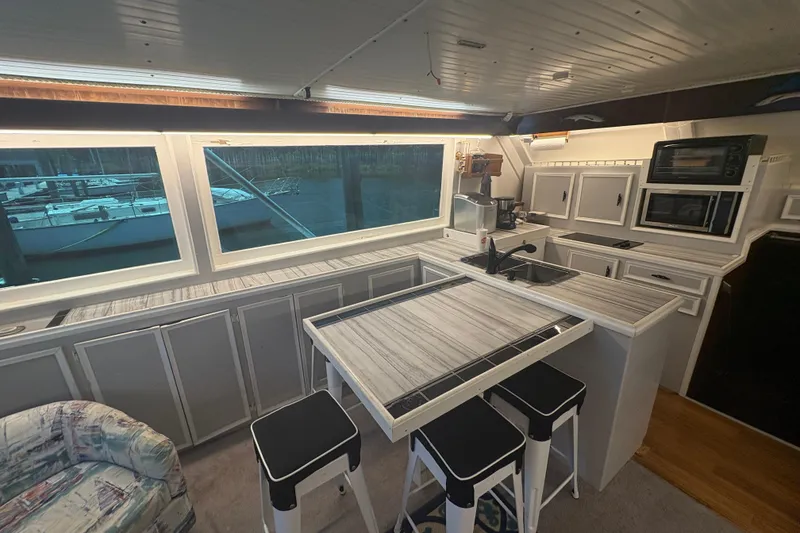 Slide: The Image of Interior of a 1973 Hatteras 53 Convertible yacht with modern kitchen and seating area. - 16