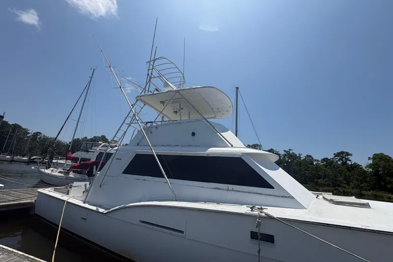 Slide: The Image of 1973 Hatteras 53 Convertible yacht docked under clear blue sky. - 95