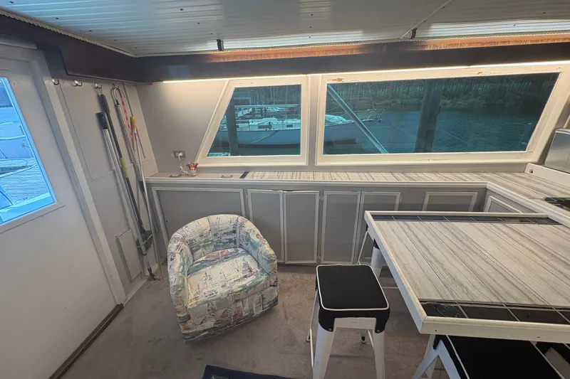 Slide: The Image of Interior of a 1973 Hatteras 53 Convertible yacht with seating and large windows. - 21