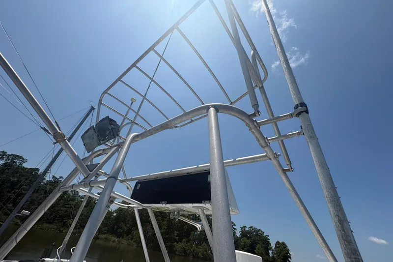 Slide: The Image of Aluminum tower structure on a 1973 Hatteras 53 Convertible boat under a clear blue sky. - 82