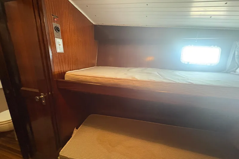 Slide: The Image of Interior cabin of 1973 Hatteras 53 Convertible yacht with wooden bunk beds. - 59