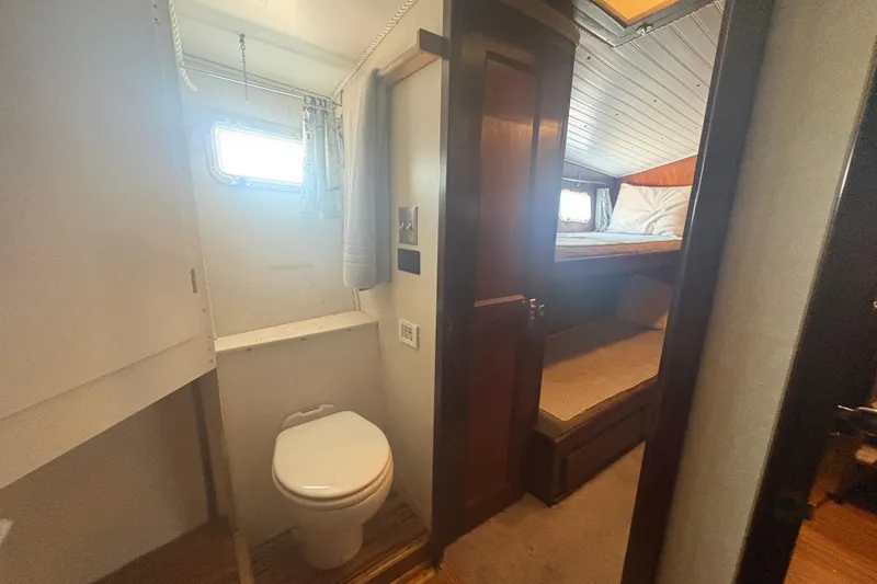 Slide: The Image of Interior of 1973 Hatteras 53 Convertible yacht showing compact bathroom and cozy sleeping area. - 61