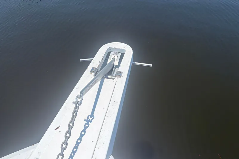 Slide: The Image of Bow of 1973 Hatteras 53 Convertible yacht with anchor chain over water. - 116