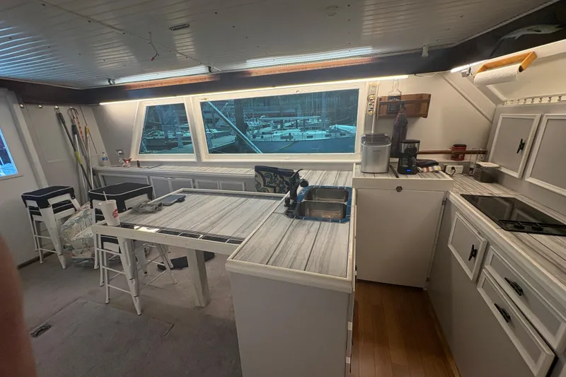 Slide: The Image of Interior of a 1973 Hatteras 53 Convertible yacht with modern kitchen amenities. - 22