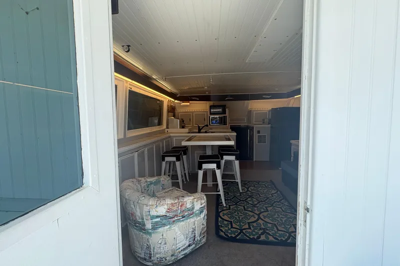 Slide: The Image of Interior of a 1973 Hatteras 53 Convertible yacht with modern kitchen and seating area. - 14