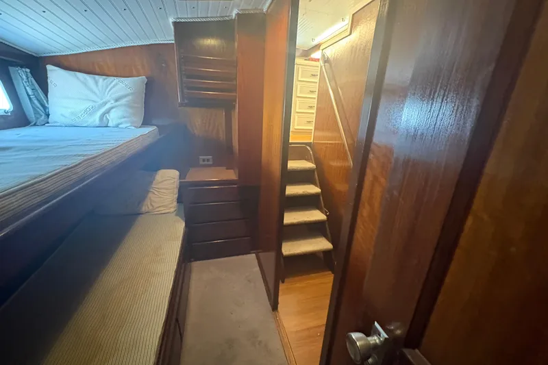 Slide: The Image of Interior of 1973 Hatteras 53 Convertible yacht with wooden paneling and bunk beds. - 61