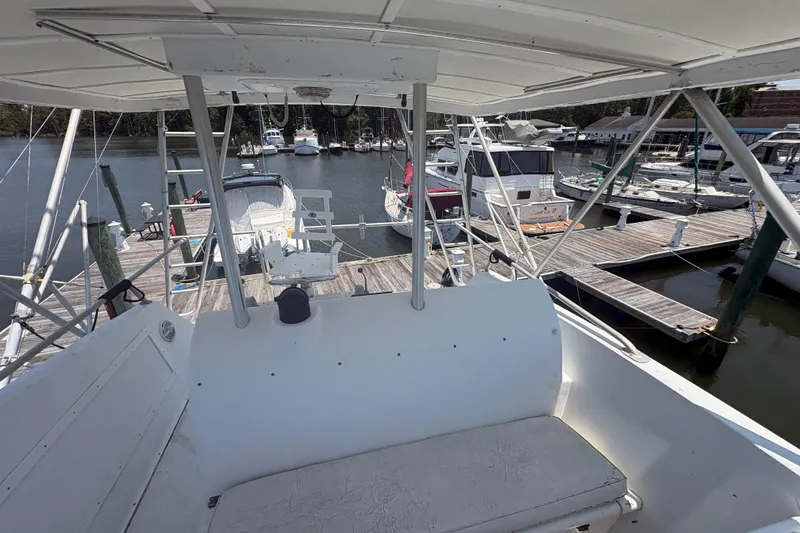 Slide: The Image of 1973 Hatteras 53 Convertible yacht docked at a marina, view from the helm. - 76